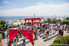 An Indian bride and groom have an vibrant beach wedding ceremony.