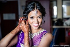 An Indian bride gets ready for reception in a purple lengha.