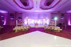 An Indian bride and groom celebrate at their wedding reception.