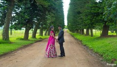 An Indian bride and groom pose for wedding portraits.