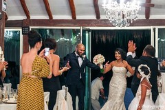 An Indian bride and groom celebrate at their wedding reception.