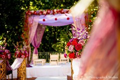 For their Indian wedding ceremony, this bride and groom opt for a traditional floral mandap and red and white jai malas!