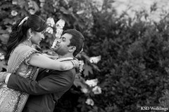 An Indian bride and groom pose for wedding portraits.