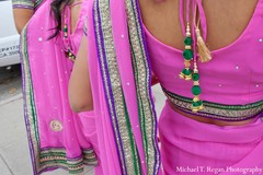 An Indian bride and groom pose with their bridal party on the beach.