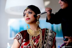 This Indian bride gets beautiful hair and makeup before her wedding ceremony.