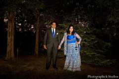 An Indian bride and groom pose for portraits before their reception.