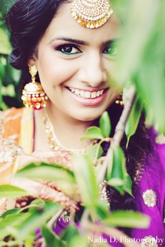 A bride poses for sangeet portraits.