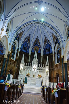 A bride and group tie the knot in Catholic wedding ceremony.