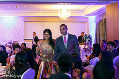 An Indian bride and groom celebrate at their reception.