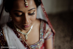 This bride prepares for her wedding day with beautiful makeup.