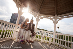 An Indian bride and groom celebrate at their wedding sangeet.