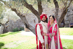 An Indian bride and groom pose for darling wedding portraits.