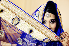 An Indian bride and groom are brilliant in royal blue for their wedding reception.