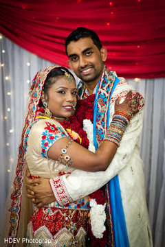 This Indian bride and groom pose for beautiful portraits after their colorful ceremony.