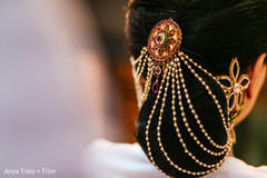 An Indian bride shows off her glam hair accessories.