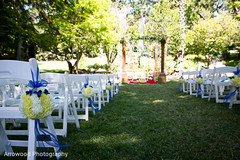 This outdoor Indian wedding ceremony includes beautiful decor.