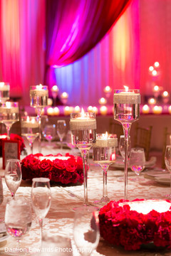 This Indian wedding reception includes beautiful red and white floral and decor.