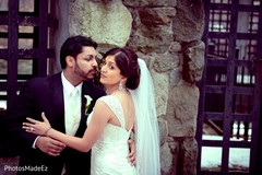 This bride and groom pose for beautiful wedding portraits.