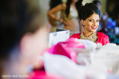 This Indian bride gets ready for her wedding with lovely makeup.