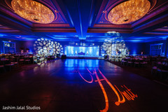 This Indian wedding reception features beautiful lighting and design.