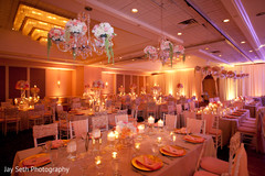 This Indian wedding reception features beautiful floral and decor.