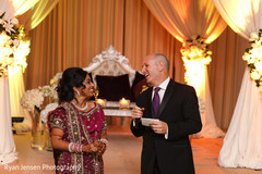 This Indian bride and her groom celebrate at their wedding reception.