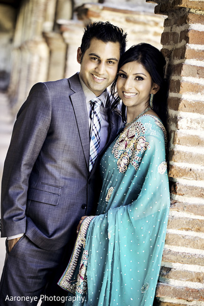 Indian couple posing outdoors for engagement photo session. | Photo 259964