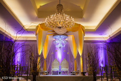 This Indian wedding reception features beautiful yellow floral and decor.