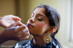 This Indian bride gets all dolled up with lovely makeup for her wedding.