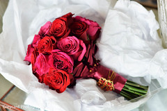 This Indian bride opts for a red rose bridal bouquet for her wedding day.