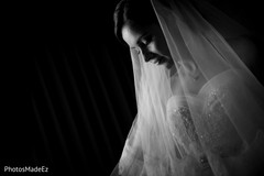 The bride takes portraits before their American ceremony.