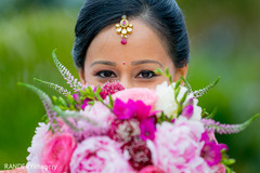 An Indian bride and groom wed in a traditional ceremony among family and friends.