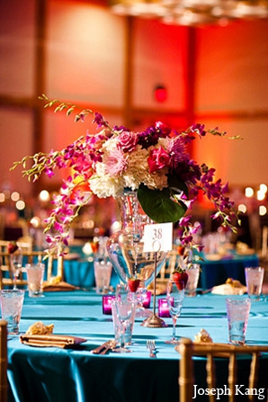 Indian wedding reception decor floral arrangement table settings in ...