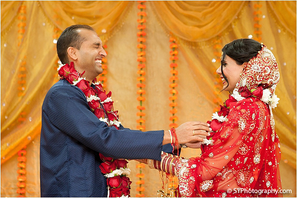 An Indian bride and groom share laughter at this beautiful Indian wedding.