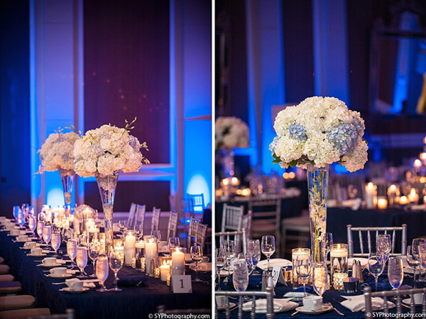 Tall floral centerpieces fill this Indian wedding reception.