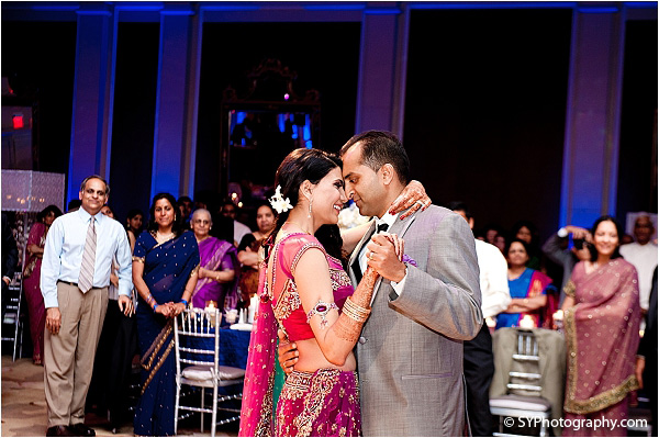 An Indian bride and groom slow dance at the Indian wedding reception.