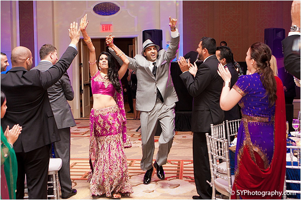 An Indian bride and groom make a grand entrance into their Indian wedding reception.