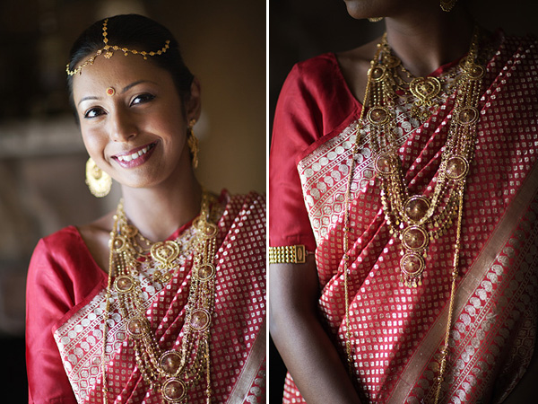 An Indian bride wears a red bridal sari and gold bridal indian jewelry.