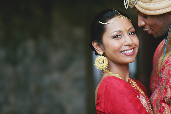 An Indian bride smiles at her fusion Indian wedding.