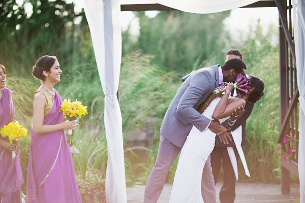 An Indian bride and groom kiss at this fusion Indian wedding.