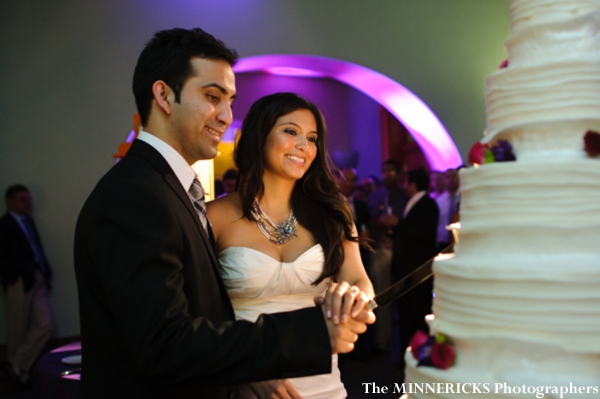 Indian bride and groom cut into indian wedding cake.