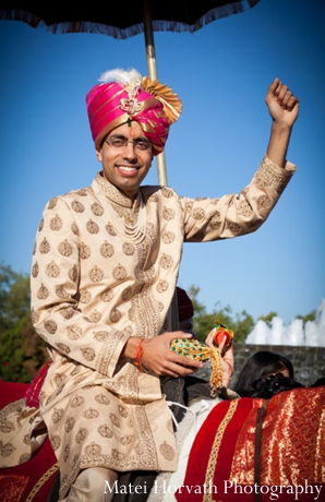 An Indian groom arrives to his Indian wedding at a baraat.