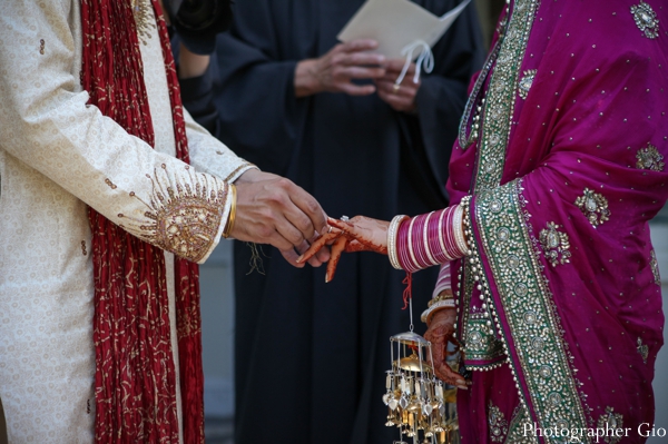 A groom marries his Sikh Indian bride, who wears a hot pink bridal sari.