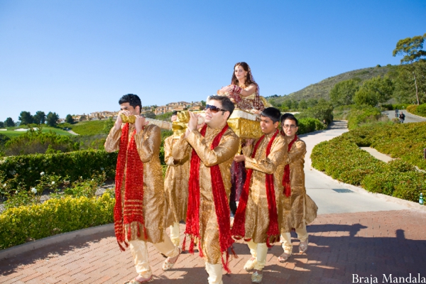 Indian bride enters Indian wedding on a palanquin.