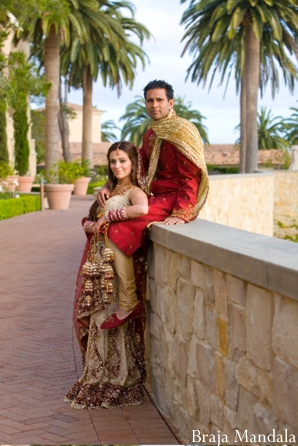 Indian bride and groom post for outdoor indian wedding photography.