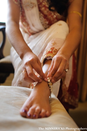 An Indian bride puts on her indian bridal jewelry anklet