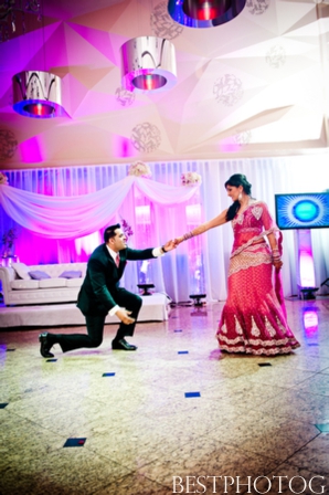 An Indian bride and groom twirl on the dancefloor of their Indian wedding reception.