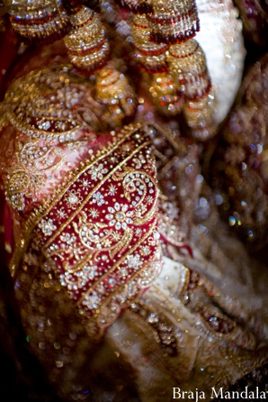 Indian wedding photography shows close up of bridal lengha.