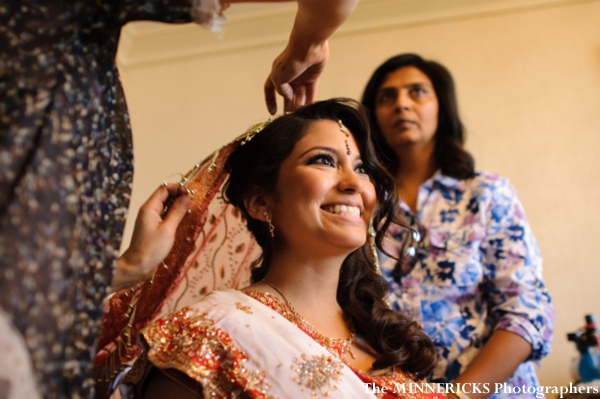 Indian bride puts on her chuni, a part of her indian bridal lengha.