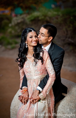 An Indian bride wears a pink Indian wedding outfit with traditional Indian bridal jewelry.